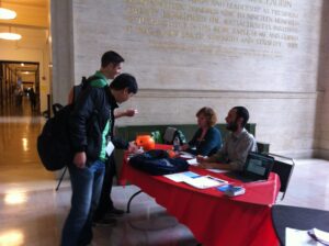 Katharine Dunn and Mark Clemente field questions at an information table during Open Access week 