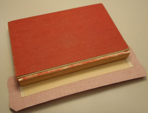 Stiff card stock inside new spine cloth