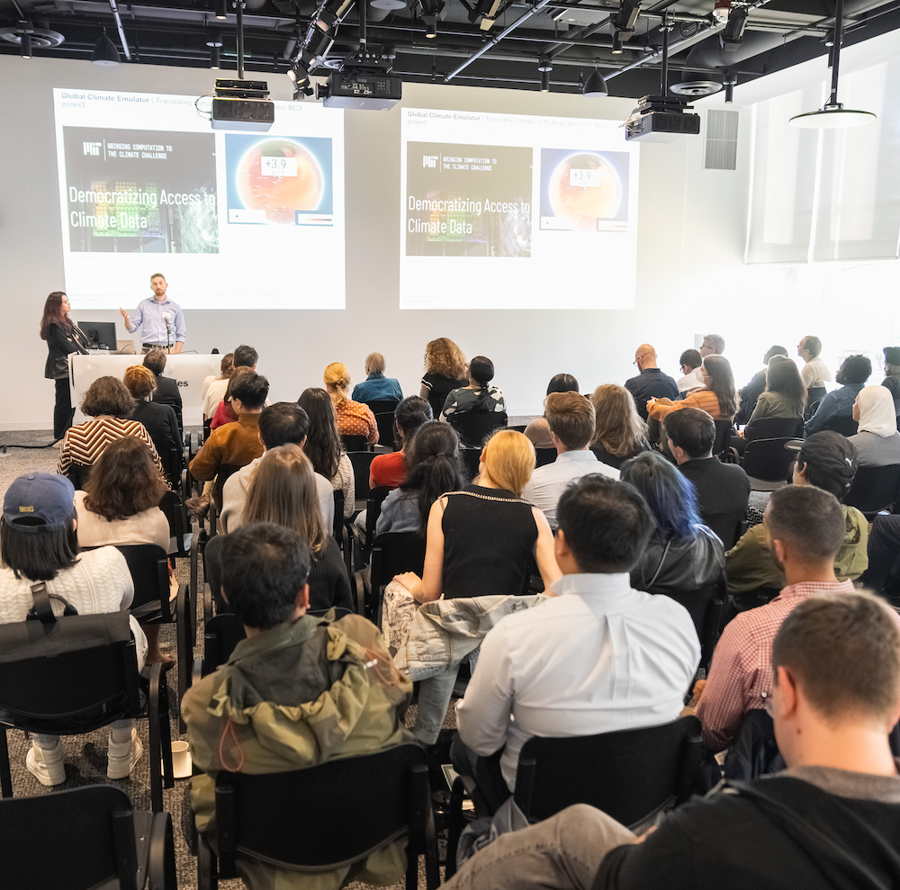 An audience in the Hayden Library Nexus watches a presentation