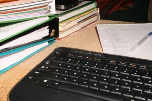 keyboard and notebooks on a desk