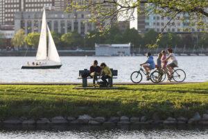 Cyclists riding along the Charles River across from MIT's Campus