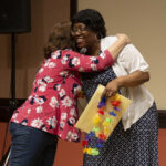 Infinite Mile Awards committee member Lisa Horowitz embraces award recipient Barbara Williams