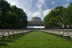 MIT building 10 lawn with graduation chairs and stage