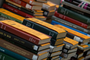Stacks of books with yellow BorrowDirect labels on the covers.