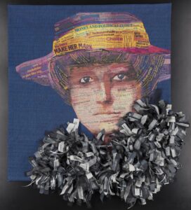 Quilt depicting a woman in a hat wearing a three-dimensional ruffled scarf.