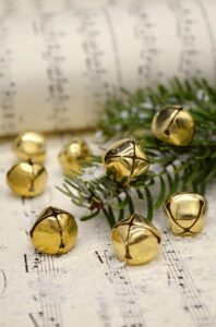 Sheet music with holiday greens and bells