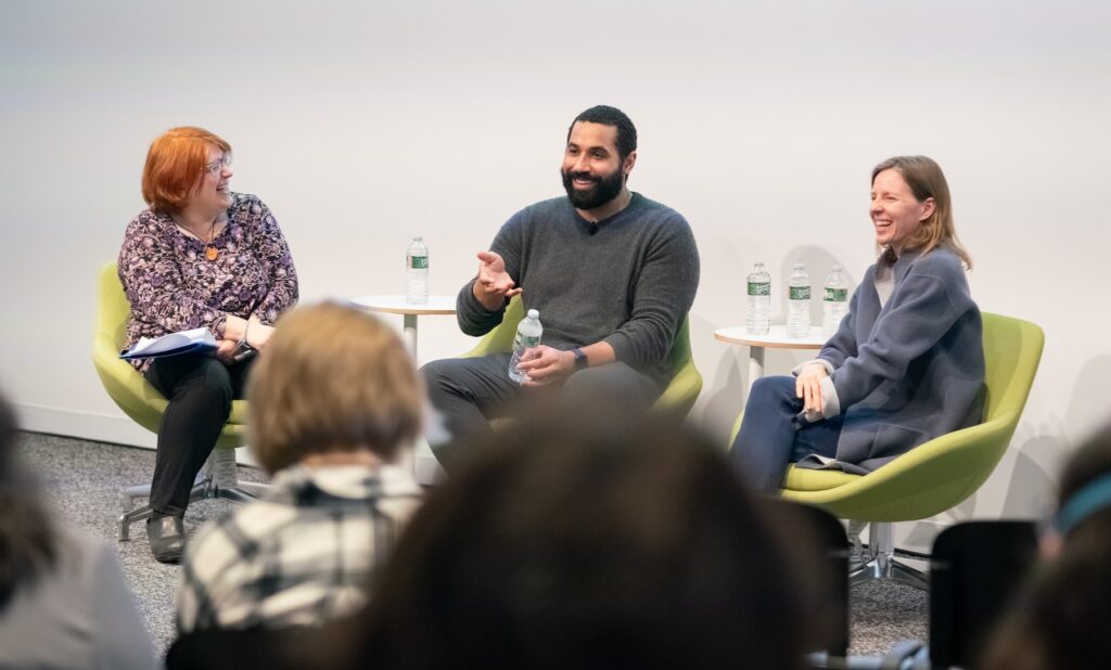 John Urschel speaks in front of an audience in the Nexus