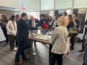 A group of people gathered around a display case in the Maihaugen Gallery